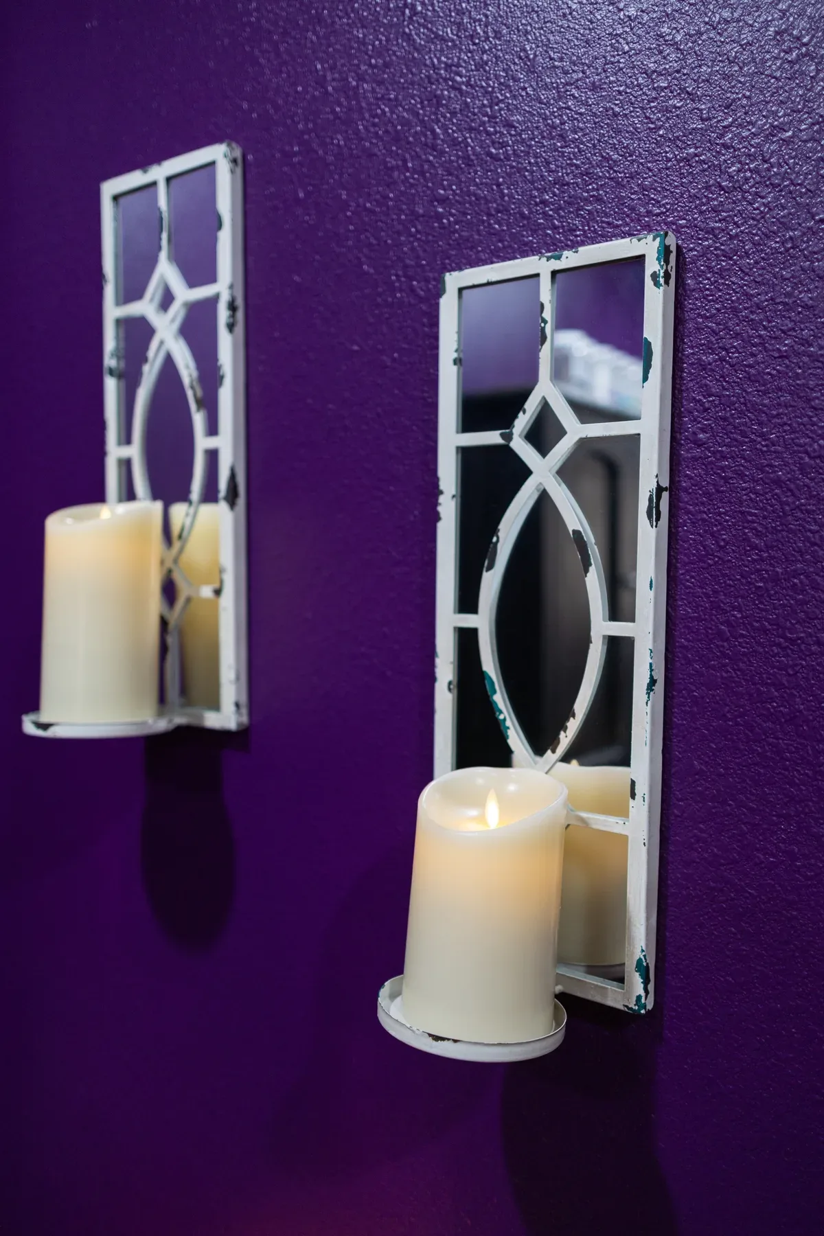 Candles on the wall of a treatment room at Evolution of Beauty