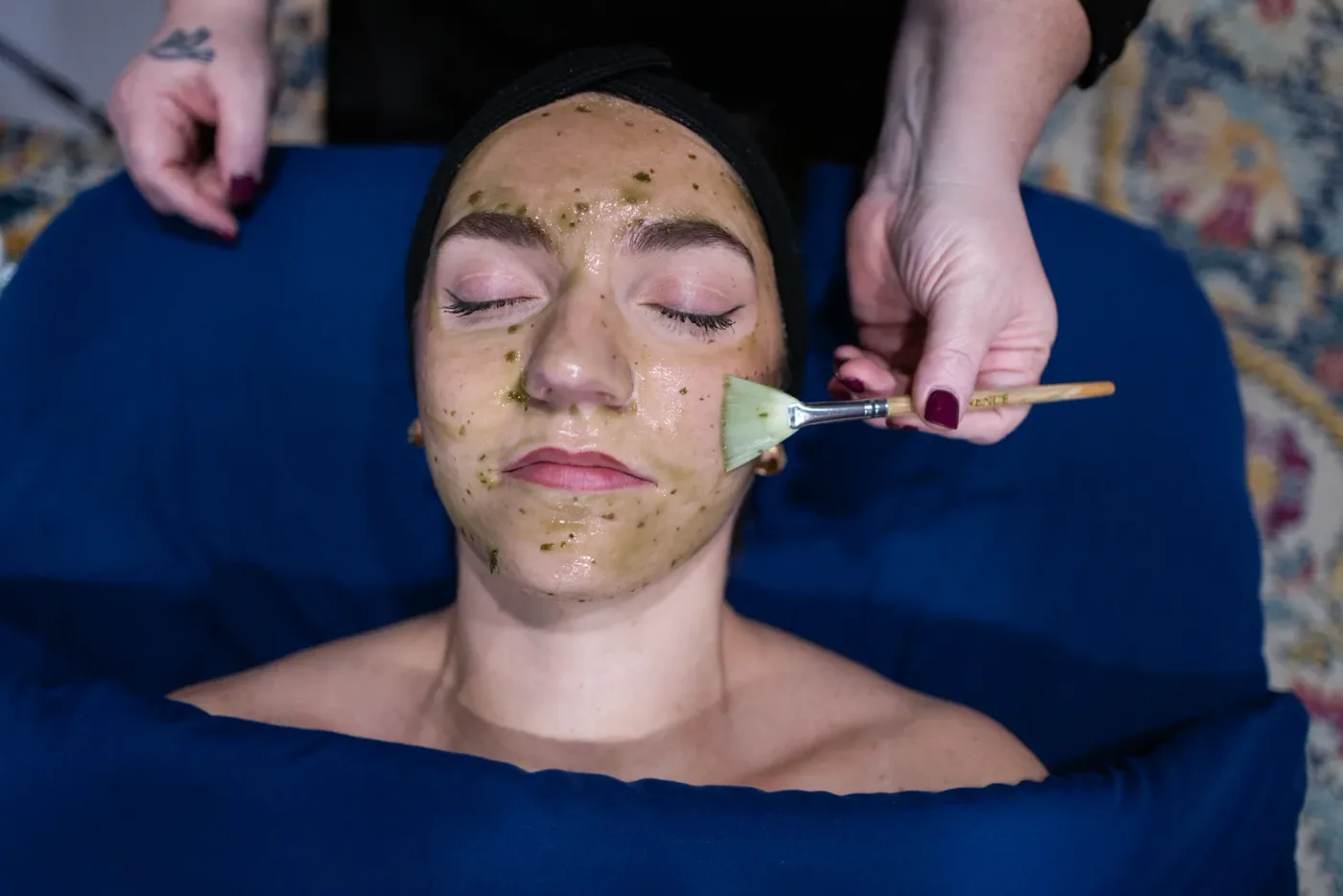 A client having a treatment mask applied during a custom facial at Evolution of Beauty in Marshall, Minnesota
